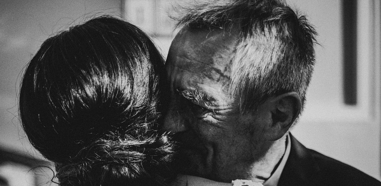 A father hugging his daughter.