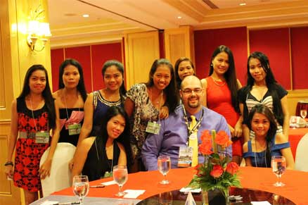 Foreign man at a dinner table surrounded by beautiful Cebu women